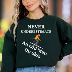 "Never Underestimate An Old Man On Skis" | Funny Graphic Unisex Adult Sweatshirt | Skiing Humor